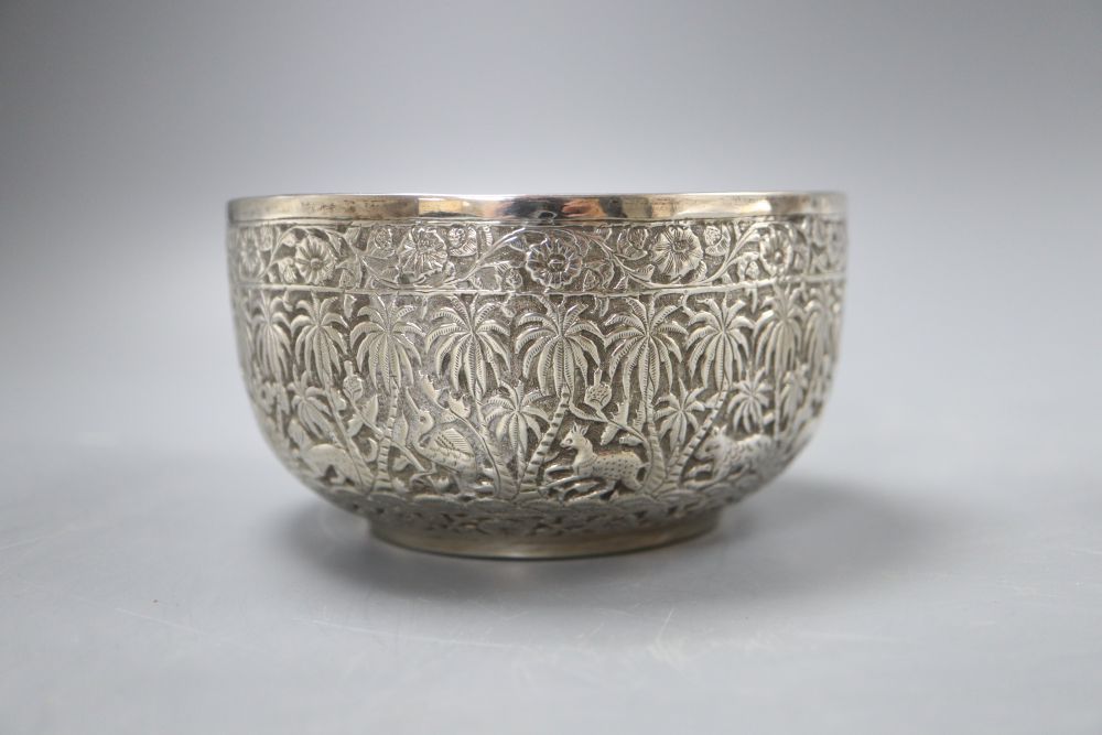 An Indian white metal sugar bowl decorated with a continuous frieze of animals in the jungle, diameter 11cm